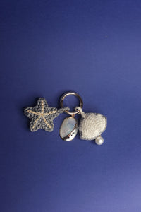 Coto mother of pearl, starfish and raffia shell charm
