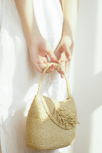 Tải hình ảnh vào Thư viện hình ảnh, Lubéron is a handbag with short straps that are easy to grasp. It is constructed of raffia and has a bouquet of rice flowers connected to the body to add highlights. You can use the Lubéron bag as a night party accent or combine the two styles to be the party&#39;s focal point.
