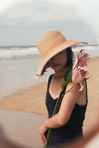 Sunrise raffia straw hat with a round crown and V-shape detail on the brim