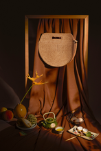 Load image into Gallery viewer, Marjolie bag, FWhen you look at marjorlie you can think of pictures of faces. The curve of the bag is sewn smooth. The outer surface is natural raffia knit creating a balance between color and shape. Thick lining.ormscape, Raffia, soft moon light, Eco luxury