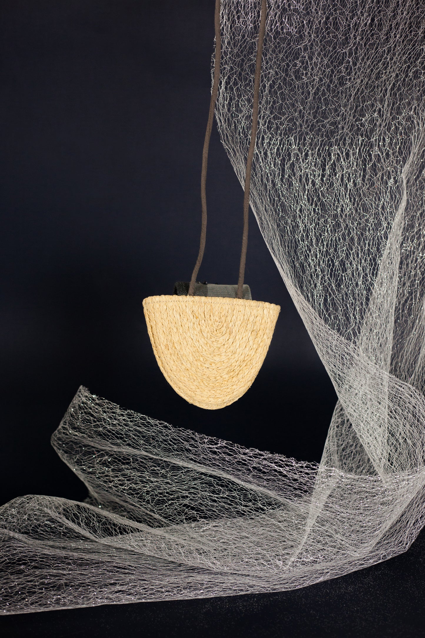 The combination of jewelry and wallet. The starry sky is depicted in decorative accents. The Thinking of Stars Neck Bag is made with natural Raffia, eco linen and some subtle touches to draw attention to the complexity. To complete a distinct contemporary look, wear it as a necklace, crossbody or even paired together as a bag.