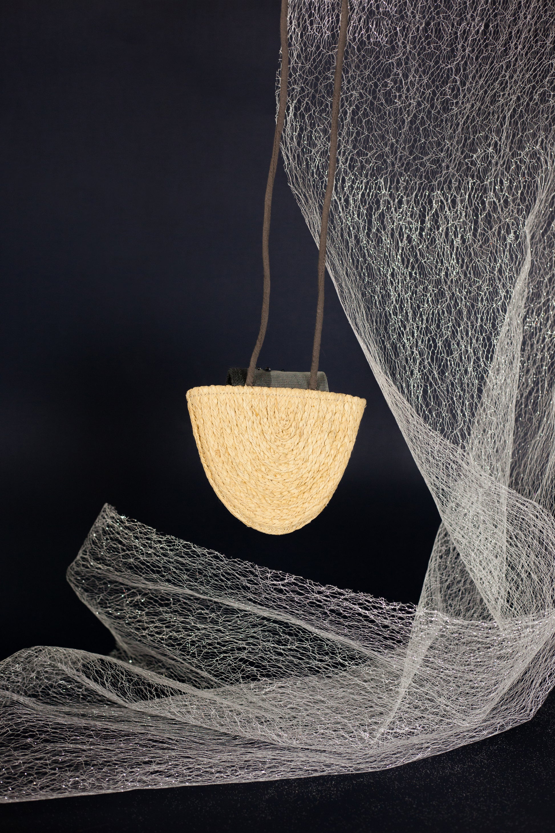 The combination of jewelry and wallet. The starry sky is depicted in decorative accents. The Thinking of Stars Neck Bag is made with natural Raffia, eco linen and some subtle touches to draw attention to the complexity. To complete a distinct contemporary look, wear it as a necklace, crossbody or even paired together as a bag.