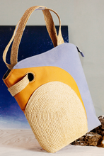 Load image into Gallery viewer, The Life on Mars bag, shaped quite like a tote bag, is handcrafted from natural Raffia, surrounded by layers of premium cotton and delicately contoured. There is a &quot;secret pocket&quot; inside the raffia piece on the front.